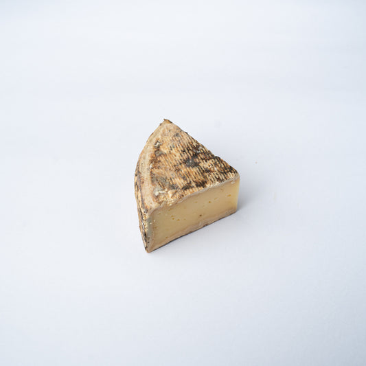A 200g wedge of Tomme de Savoie cheese.