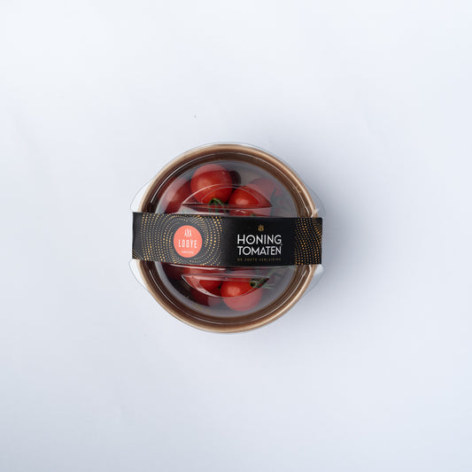 A cardboard tub of Honing Cherry Tomatoes 180g with a plastic lid.