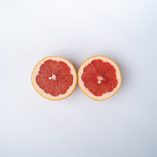 A ruby grapefruit cut into two halves.