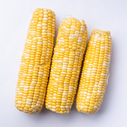 Three cobs of corn, each one slightly smaller than the last.