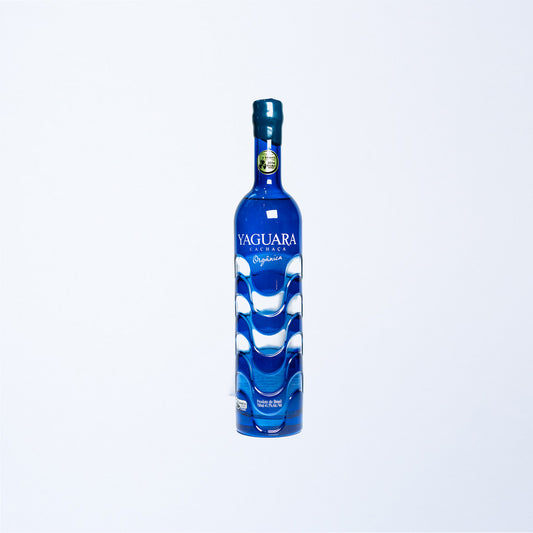 An ornate blue bottle of Yaguara Blue Cachaca.