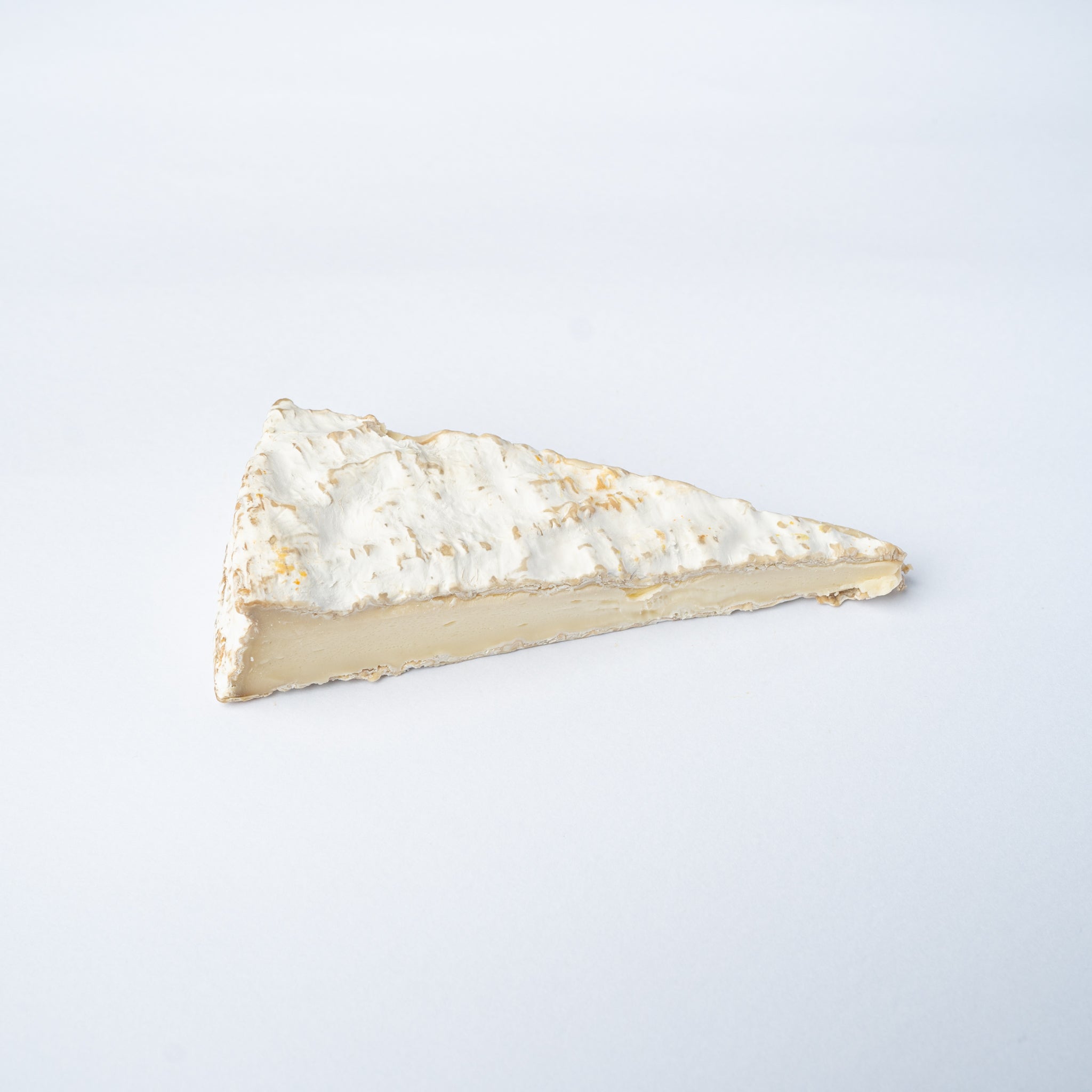 A 200g wedge of Brie de Meaux cheese.