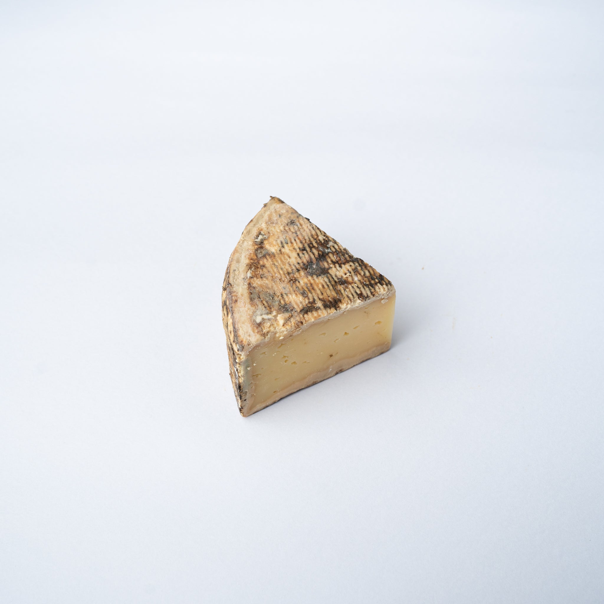 A 200g wedge of Tomme de Savoie cheese.