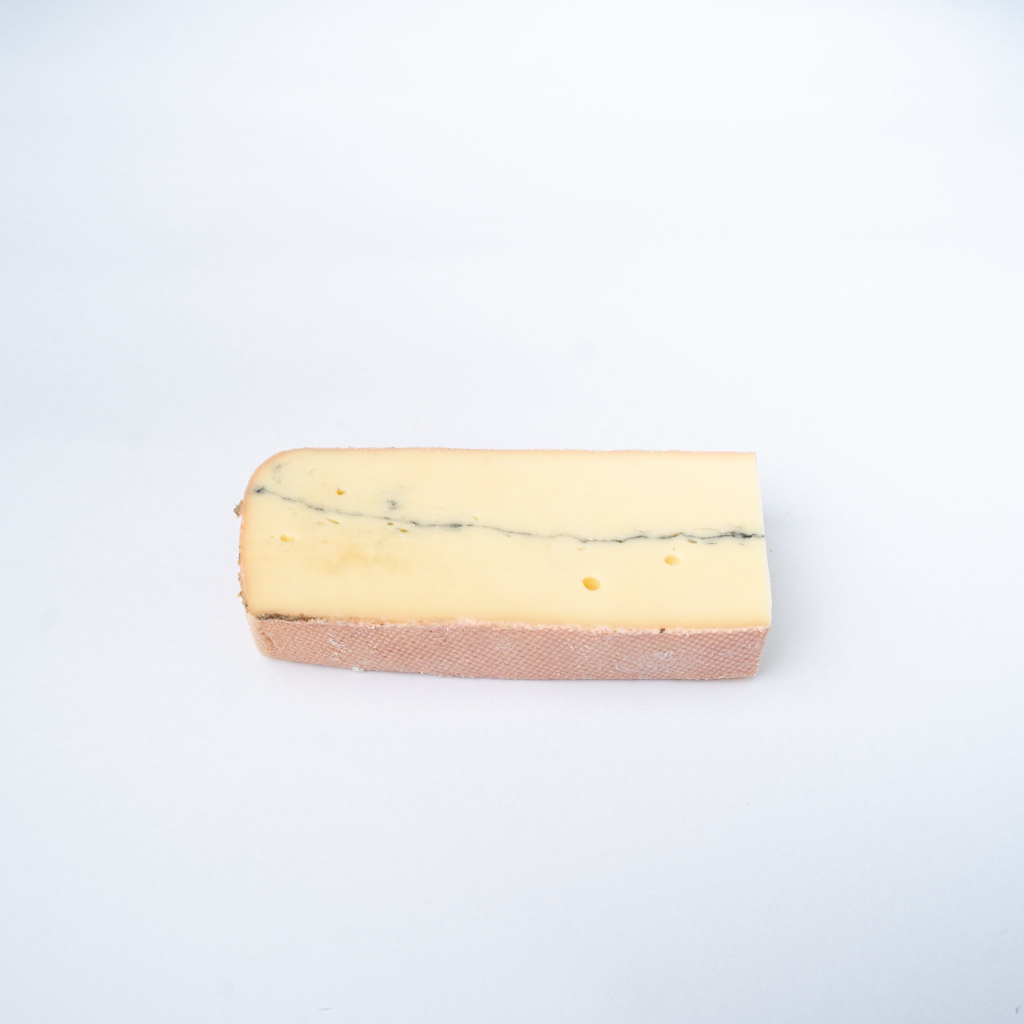 A 200g wedge of Morbier cheese.