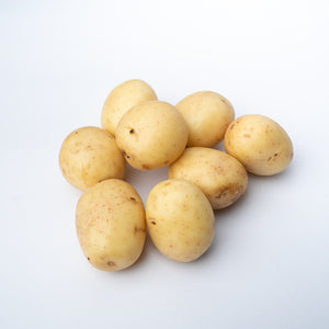 A small pile of raw baby potatoes.