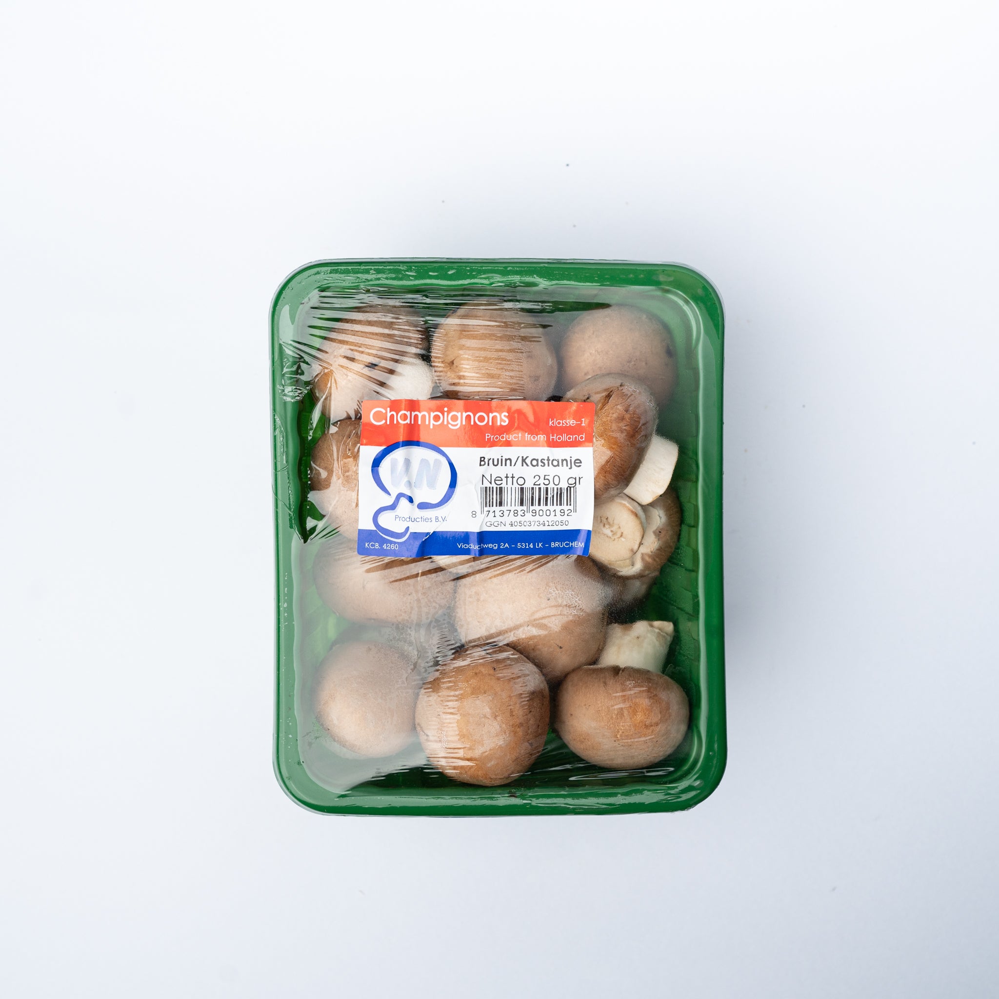 A plastic box of brown mushrooms.