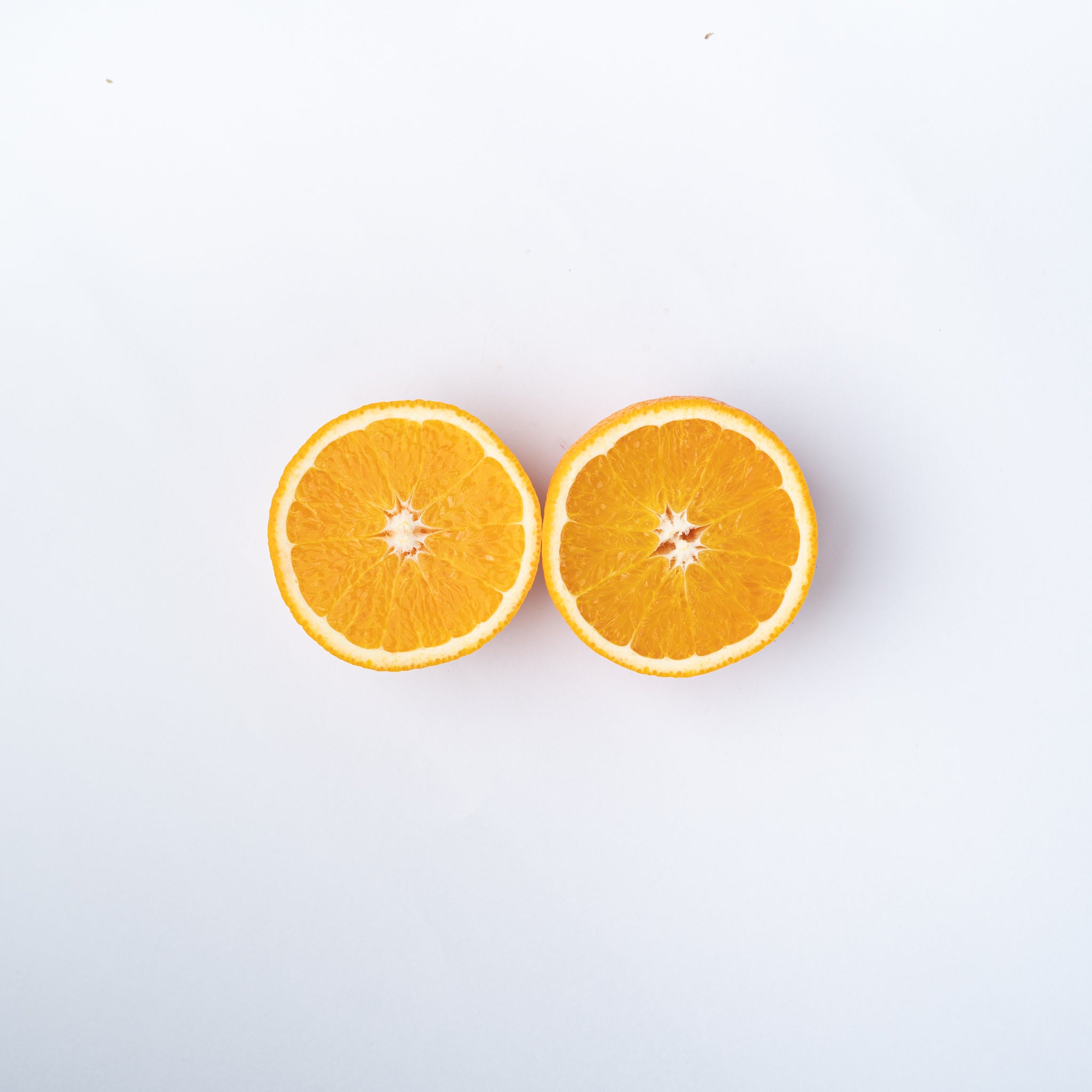 An orange cut into two halves.