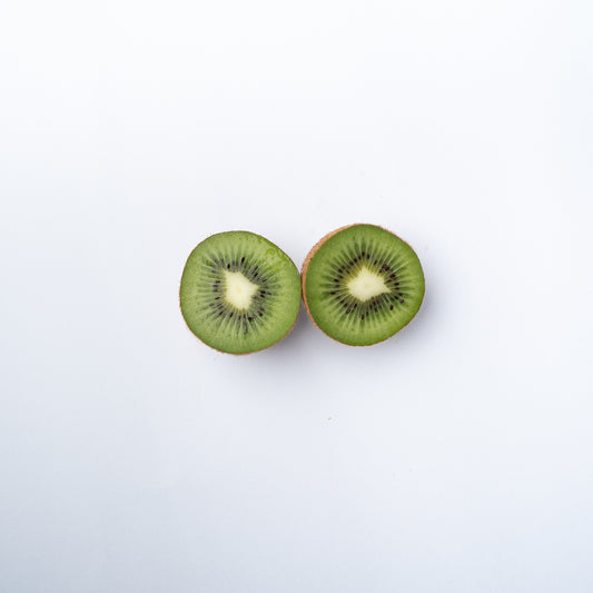 A kiwifruit cut into two halves.