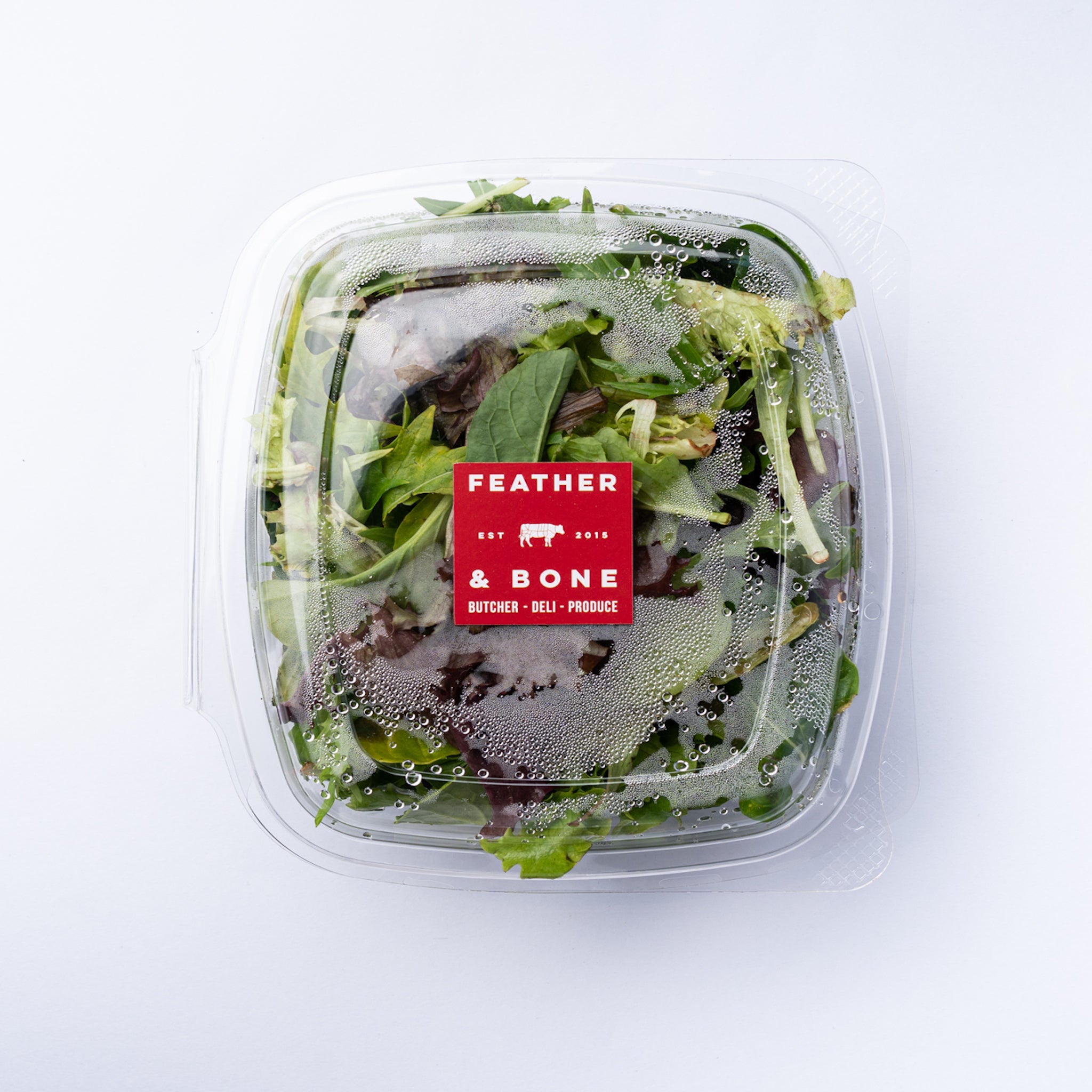 A plastic box of Mixed Leaves with a red sticker.