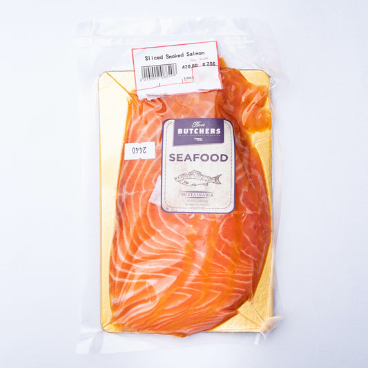 Smoked Salmon on a gold cardboard board in a vacuum bag with a purple Three Butchers label.
