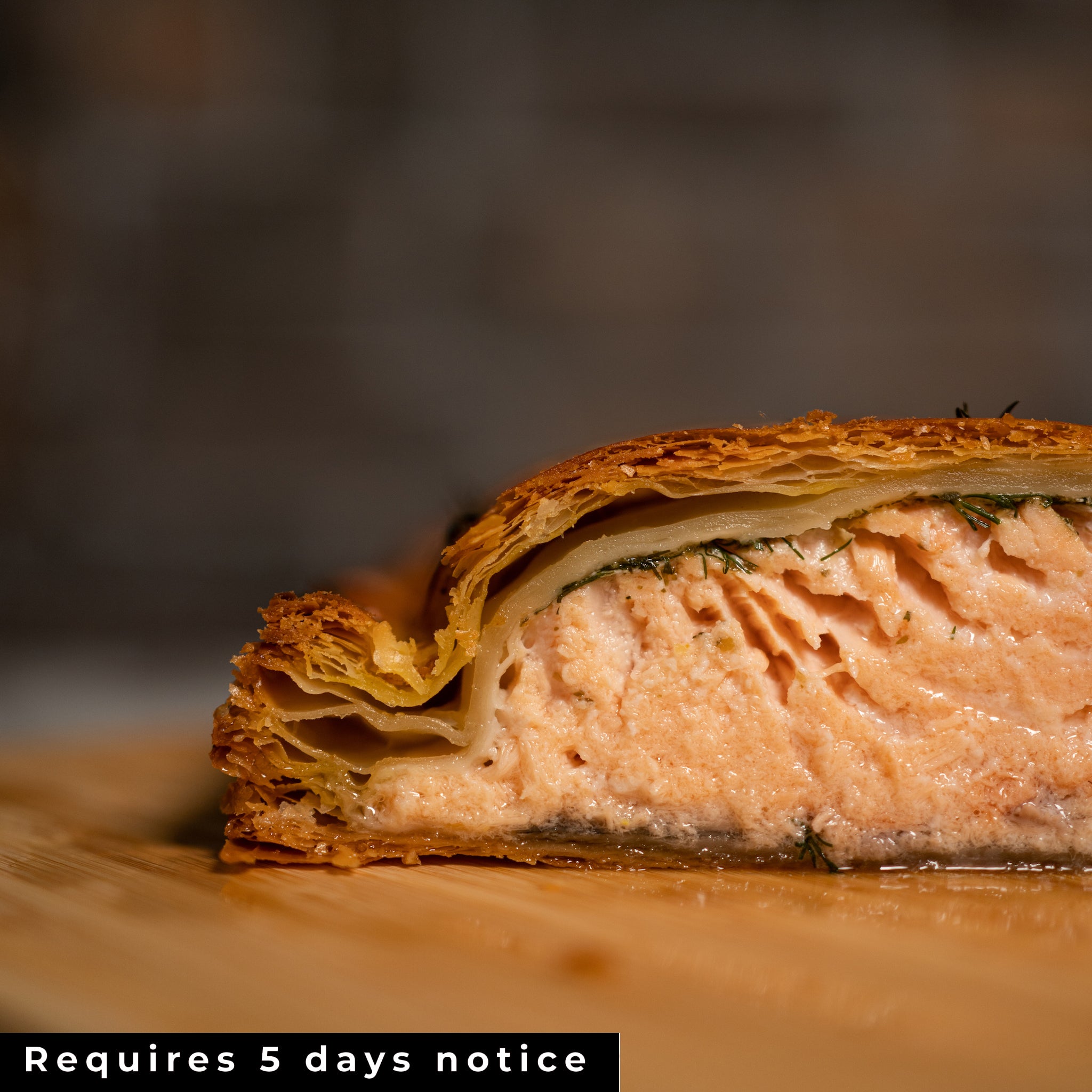 A SALMON EN CROÛTE cut open revealing the perfectly cooked salmon.