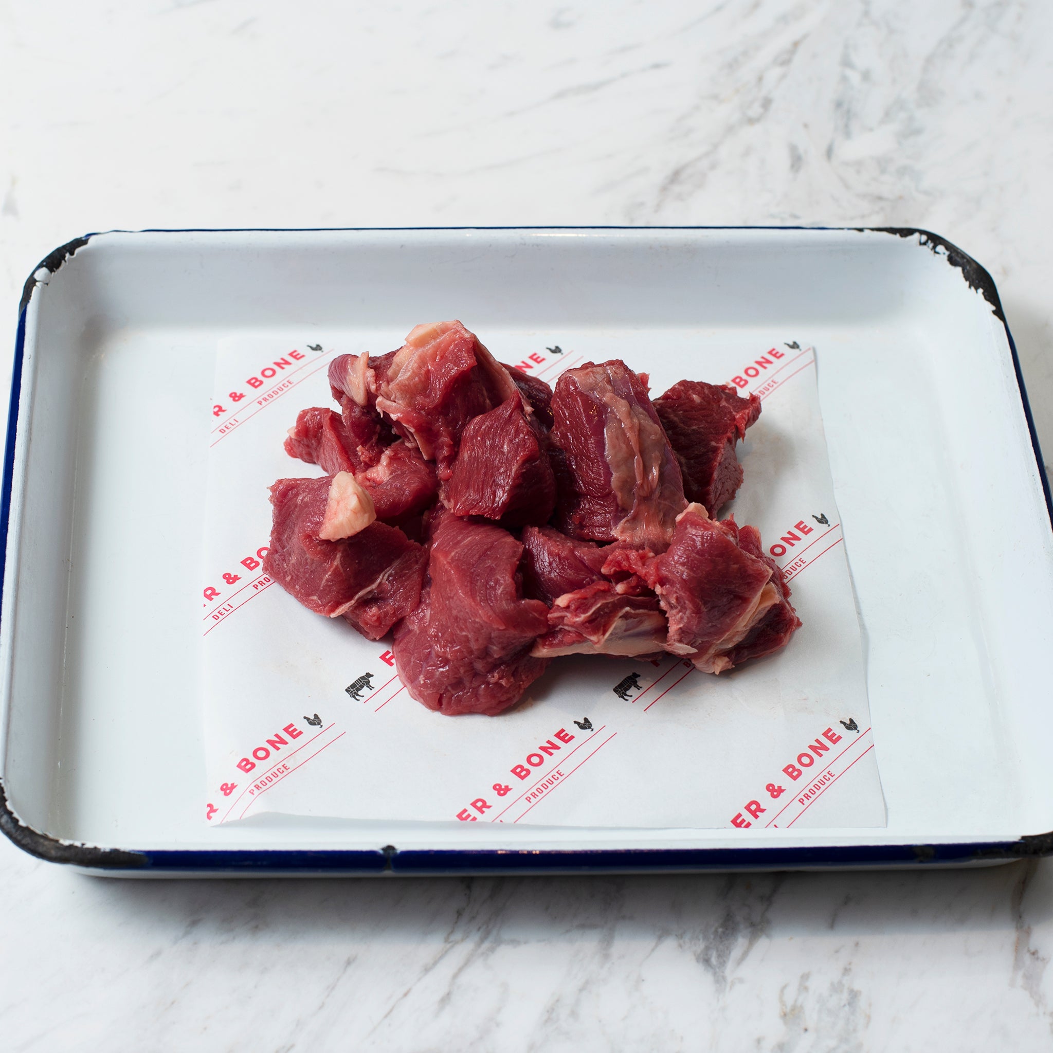 Grass Fed Diced Beef on an enamel tray.