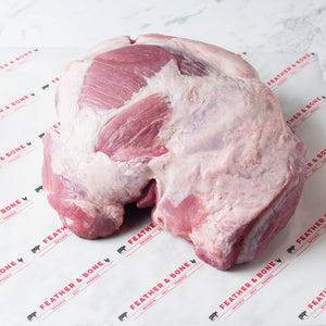 A Free Range Boneless Pork Shoulder on Feather & Bone branded butcher's paper.