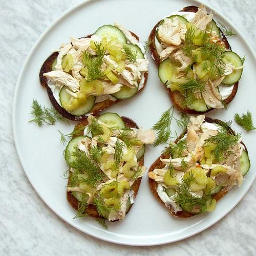 Open sandwiches with dip and slices of celery.