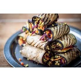 Grilled eggplant rolled around a filling and staked up.