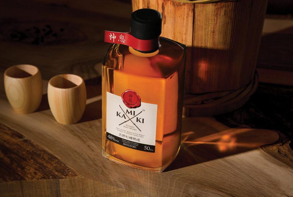 A bottle of 	 Kamiki Malt Whiskey and two glasses.
